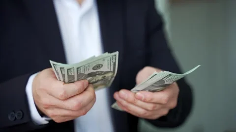 Close up. Male hands count one hundred dollar US bills. Asian businessman  Stock Footage 310688804