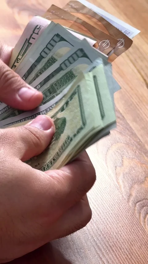 Close-up of male hands counting a stack of hundred-dollar US banknotes. Stock Footage 264980184