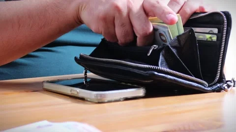 Close-up of male hands counting a stack of hundred-dollar US banknotes. Stock Footage 264982944