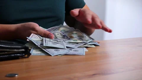 Close-up of male hands counting a stack of hundred-dollar US banknotes. Stock Footage 264982980