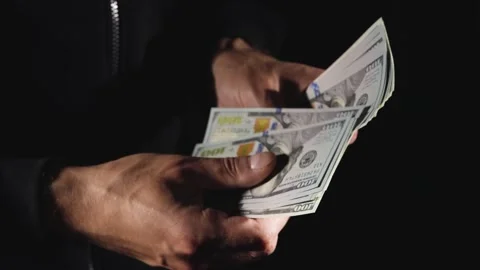 Close-up of male hands counting a stack of hundred-dollar US banknotes. a busine Stock Footage 276891971
