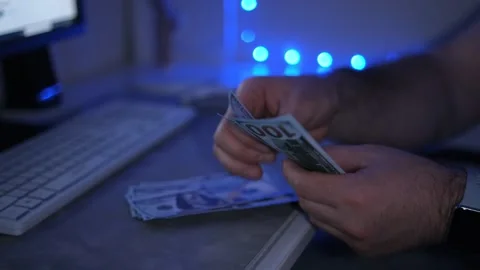 Close up of male hands counting US dollar banknotes at the table in front a Stock Footage 246900095