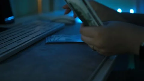 Close up of male hands counting US dollar banknotes at the table in front a Stock Footage 267865626