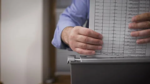 Close-up of male hands destroy documents. Female hands serving reports for Stock Footage 62983733