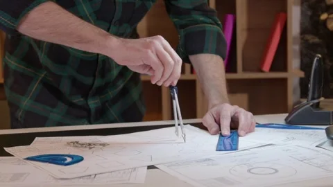 Close-up of male hands with divider drawing design sketch on drafting paper Stock Footage 275229593
