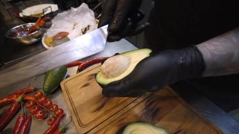 Close up male hands extracting a bone from a ripe avocado Stock Footage 105271973
