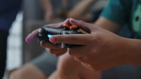 Close-up of male hands with game console playing video games, entertainment 库存影片 334653137