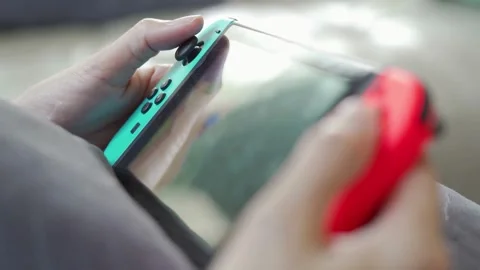 Close-up of male hands with game console playing video games, entertainment 스톡 동영상 334653650