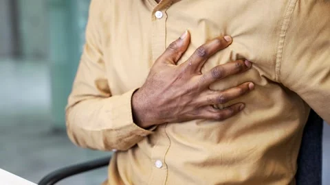 Close up of male hands holding chest because of severe heart attack. Sick  動画素材 348734341