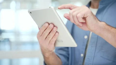 Close up of male hands holding digital tablet at workplace in modern business  Stock Footage 305698723