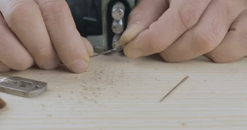 Close-up of male hands inserting black thread into a needle for sewing. 4k Stock Footage 121587977