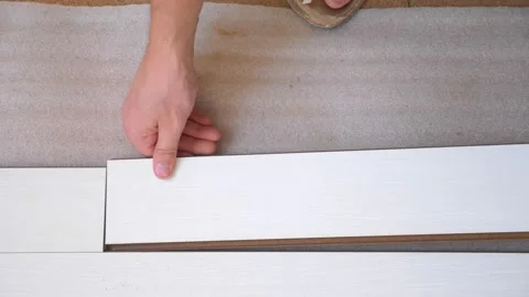 Close-up. male hands install white laminate indoors Video stock 145966997