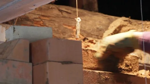 Close-up of male hands making a bricking, rustic stove Stock Footage 123718936