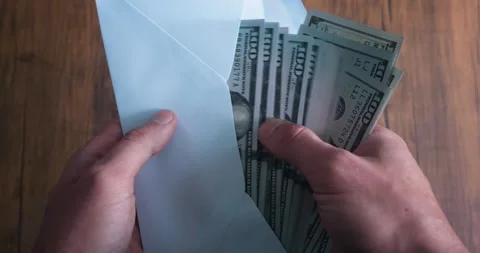 Close-up male hands open an envelope and count cash money illegally earned Stock Footage 231021239
