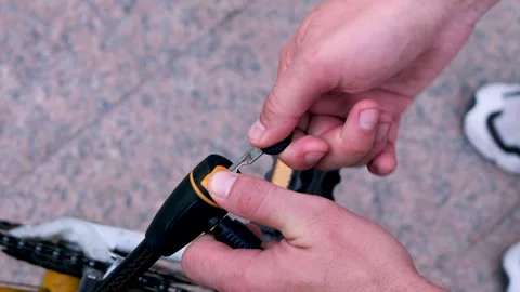 Close up of male hands opening bicycle lock with key Stock Footage 324670757