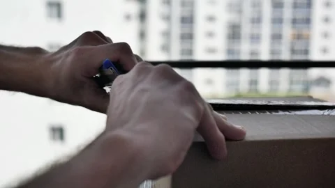 Close-up of male hands opening a parcel with ordered goods Stock Footage 311489159