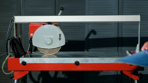 Close-up male hands put tile on cutting machine and measuring tile with ruler Video stock 90924892