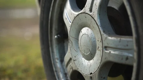 Close-up male hands remove the cap from the wheel of a car. Stock Footage 125698485