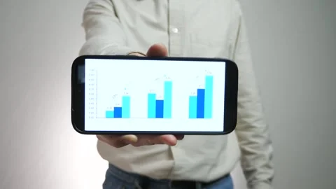 Close-up of male hands showing graph with statistics or analytics on phone. Stock Footage 310566959