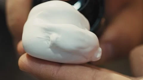 Close up of male hands squeezing shaving foam on hand Stock Footage 146647968
