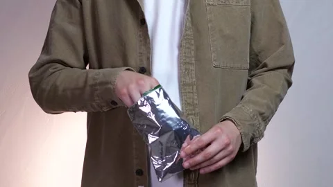 Close up of male hands taking chips from package. Stock Footage 311475619