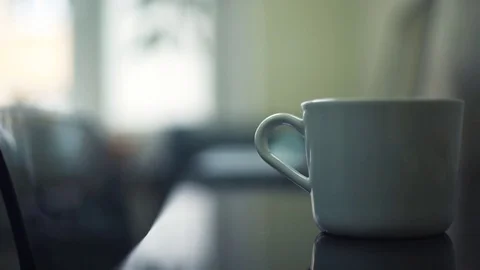 Close up of male hands taking white cup from the desk. Guy typing on laptop Stock Footage 82930002