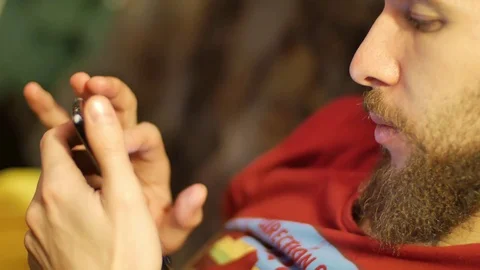 Close-up of male hands touching screen on mobile phone. P ay the video and turn Stock Footage 72587125