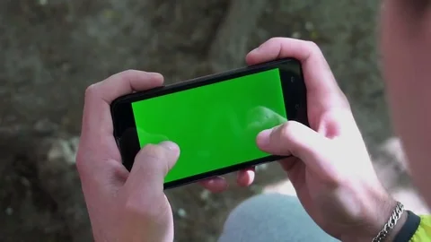 Close-up of male hands touching of smartphone. Green screen Chroma Key. Close up 库存影片 75914984