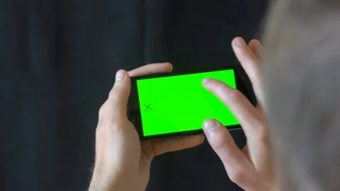 Close-up of male hands touching of smartphone. Green screen Chroma Key. Close up 스톡 동영상 76400185