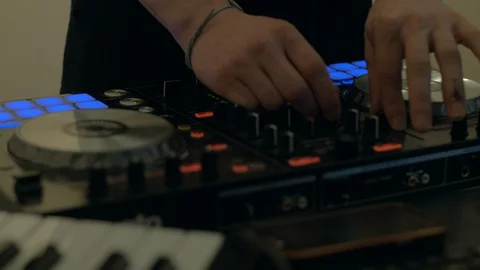 Close up of male hands turning knobs on professional DJ mixer console Stock Footage 98345531