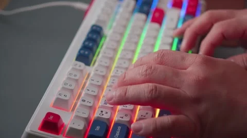 Close up of male hands typing on a backlit mechanical keyboard Video stock 336160014