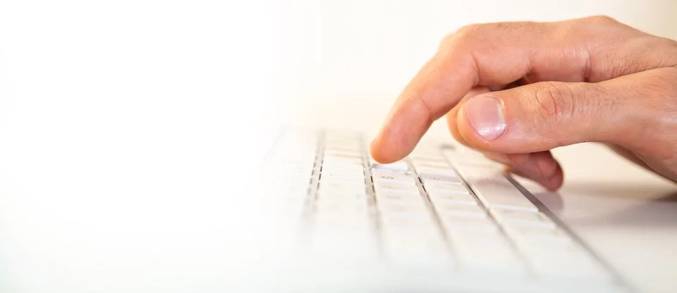 Close up of male hands typing on a computer keyboard on white background Stock Photos