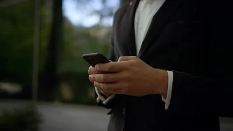 Close-up of male hands typing message on smartphone. He’s texting Messages 스톡 동영상 141254980