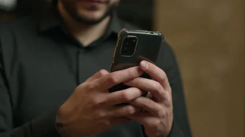 Close up male hands typing message texting sms chatting on smartphone screen Stock Footage 238704829