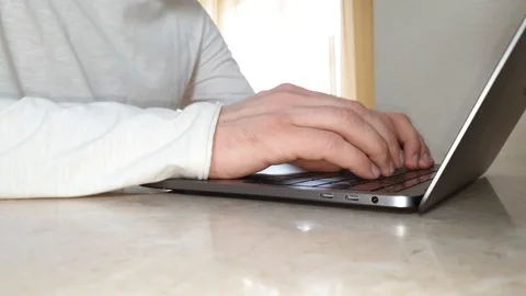 Close-up of male hands typing something on a laptop, concept of office work Video stock 125902398