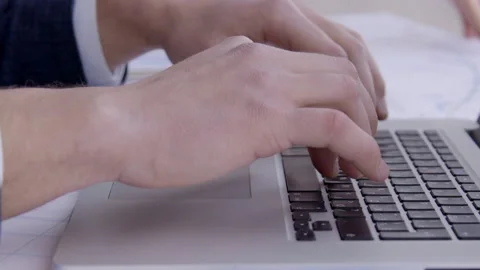 Close-up of male hands typing text on laptop keyboard. Video stock 85634678