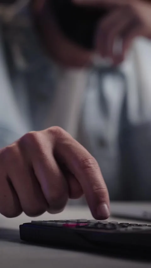 Close up male hands using calculator in front of laptop at night. Unrecognizable Stock Footage 275179823