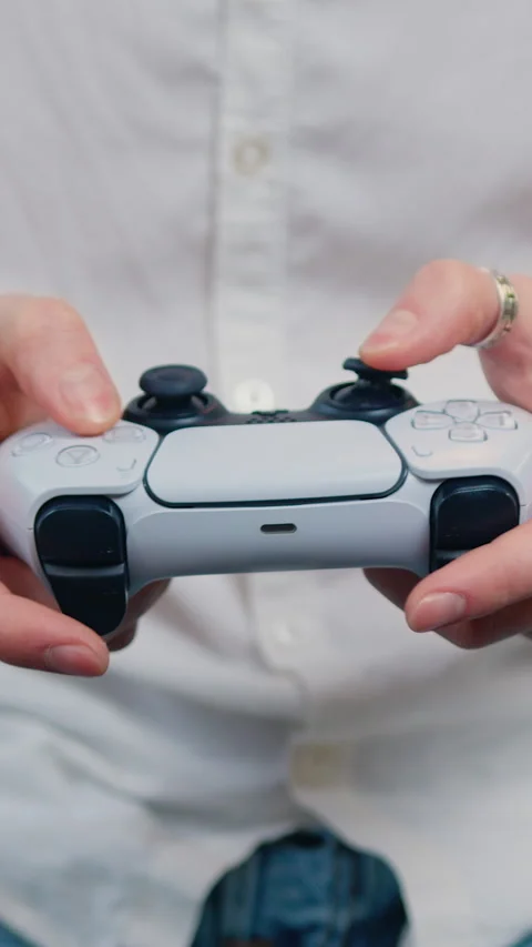Close up male hands using gamer controller in having fun alone at home in the ev Stock Footage 334675921