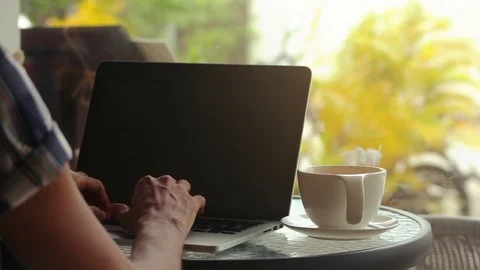 Close-up of male hands using laptop at cafe Stock Footage 72629037
