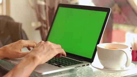 Close-up of male hands using laptop at cafe with green screen 스톡 동영상 72629218