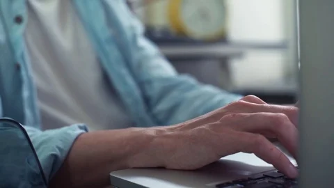 Close up male hands using laptop at kitchen. Young man working at home. Stock Footage 82932952