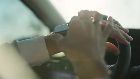 Close-up male hands using modern smart watch inside car. Life of a businessman Stock Footage 194721439