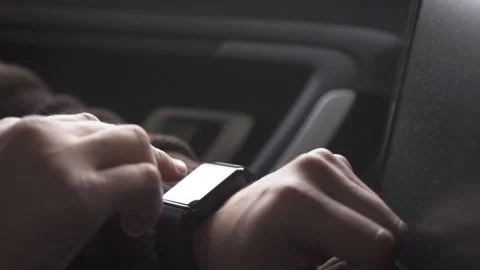Close-up of male hands using modern smartwatch in car Stock Footage 263719621