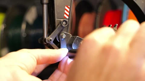 Close-up of male hands using a precision electric screwdriver to replace the Stock Footage 345090675