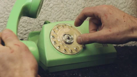 Close up of male hands using a retro green rotary telephone Stock Footage 336860653