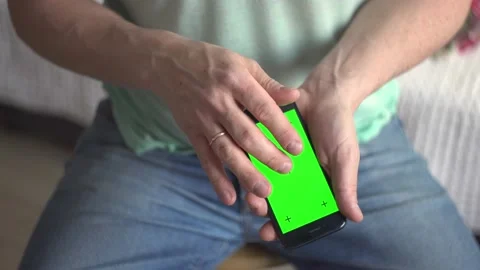 Close-up of male hands using a smartphone with a grain screen. Chroma key, se Stock Footage 170485780