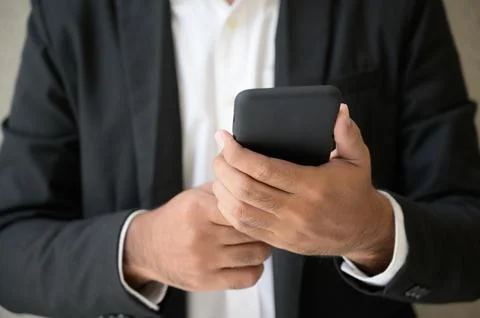 Close-up of male hands using smartphone Stock Photos