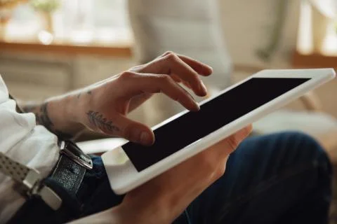 Close up of male hands using tablet with blank screen, copyspace, education and Stock Photos