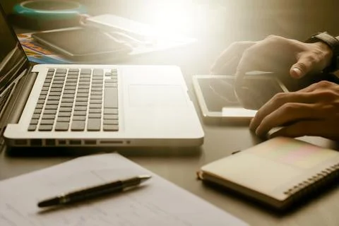 Close up of male hands using tablet on his office desk,toned with sunlight. 스톡 사진