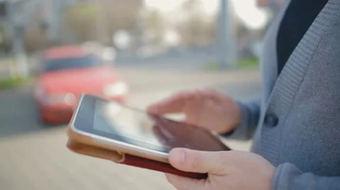 Close-up of male hands which hold the tablet and something thumbs through in it Stock Footage 62112737